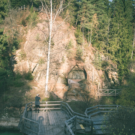 ancient sandstone cliffs with inscriptions in the Gaujas National Park, Latvia - instant vintage square photoの写真素材