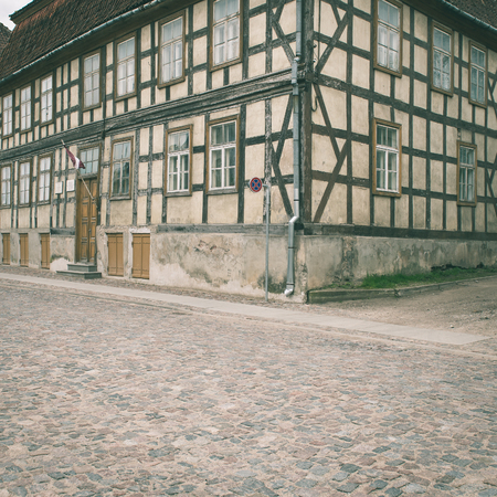 old historical buildings in old town of Kuldiga, Latvia - instant vintage square photoの写真素材