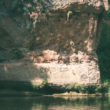 sandstone cliffs on the river shore in the Gaujas National Park, Latvia - instant vintage square photoの写真素材