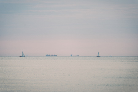 boats in the sea at sunrise - retro, vintage style look