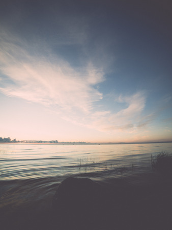 beautiful sunrise in the sea at the wild beach - retro, vintage style look