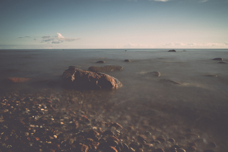 View of a rocky coast in the morning. Long exposure shot. - retro, vintage style lookの写真素材