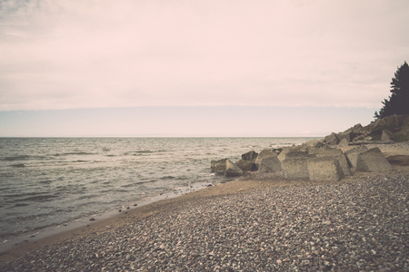 rocky beach in the baltic sea with plants and skyline - retro, vintage style lookの写真素材