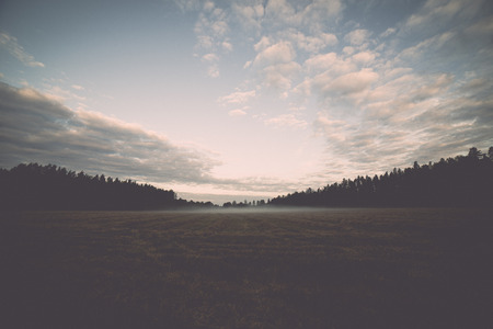 Majestic country landscape under morning sky with clouds. - retro, vintage style lookの写真素材