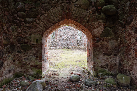 ruins of old abandoned church with red bricks and stone in early spring in Latviaの写真素材