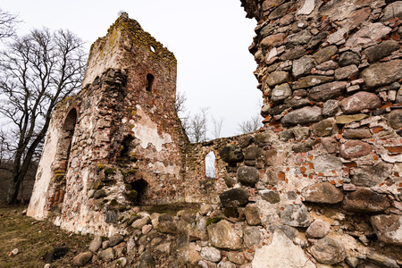 ruins of old abandoned church with red bricks and stone in early spring in Latviaの写真素材