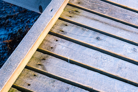 wooden boardwalk with bird watch tower in early morning with colorful sunrise in Liepaja, Latviaの写真素材