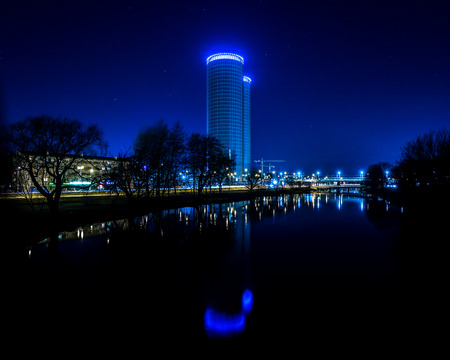 city light reflections over water at the night. colorful panorama of Riga, Latviaの写真素材