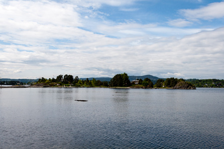 typical norway sea shore countryside landscape view with islands and treesの写真素材