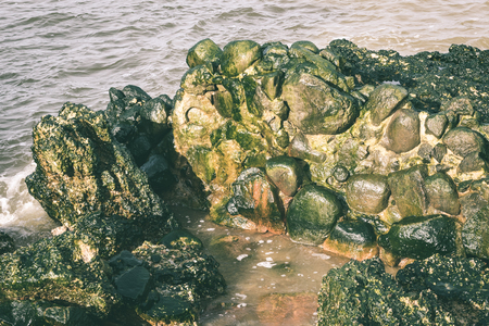 old war fort ruins on the beach with high waves in sunset. Liepaja, Latvia - vintage green lookの写真素材