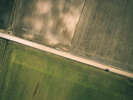 drone image. aerial view of rural area with freshly green fields, country roads and tractor tracks - vintage lookの写真素材