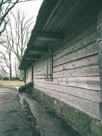 Abandoned ruins of old wooden building in latvia countryside - vintage green lookの写真素材