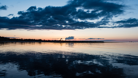 dramatic sunrise over the calm river in spring. Daugava, Latviaの写真素材
