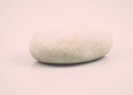 single stone isolated on white background. geological element. vintage grainy retro style film effectの写真素材