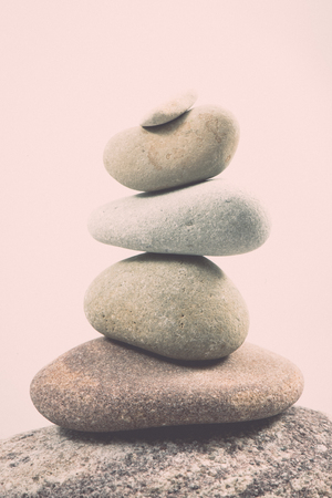 balancing stones isolated on white background. geology. vintage grainy retro style film effectの写真素材