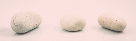 collection of stones isolated on white background. vintage grainy retro style film effectの写真素材