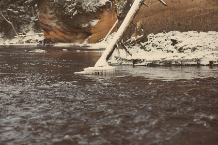 Frozen winter river landscape with ice and snow - retro vintage style lookの写真素材
