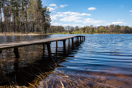 reflection of clouds in the lake with boardwalk and blue skies in backgroundの写真素材