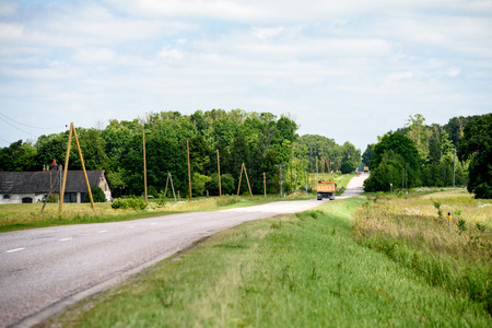 gravel road in sunny summer countryside with perspectiveの写真素材