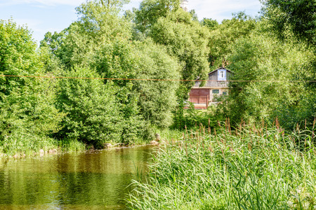 reflection of clouds in the lake with forest  and trees in backgroundの写真素材