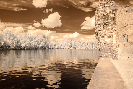 infrared camera image colored. old stone castle ruins in Koknese, Latviaの写真素材