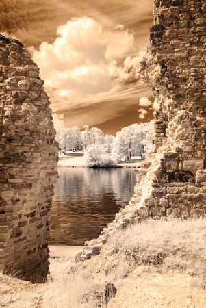 infrared camera image colored. old stone castle ruins in Koknese, Latviaの写真素材