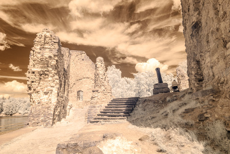 infrared camera image colored. old stone castle ruins in Koknese, Latviaの写真素材