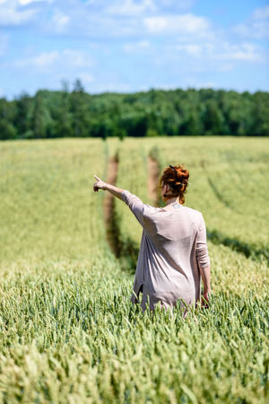 woman in Wheat Field enjoying silence and summer heatの写真素材