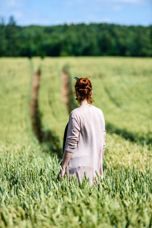 woman in Wheat Field enjoying silence and summer heatの写真素材