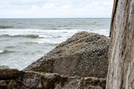 old war fort ruins on the beach with high waves in sunset. Liepaja, Latvia. storm aproachingの写真素材