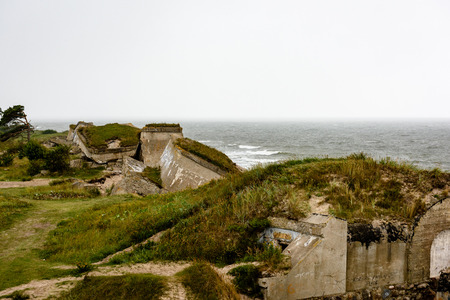 old war fort ruins on the beach with high waves in sunset. Liepaja, Latvia. storm aproachingの写真素材