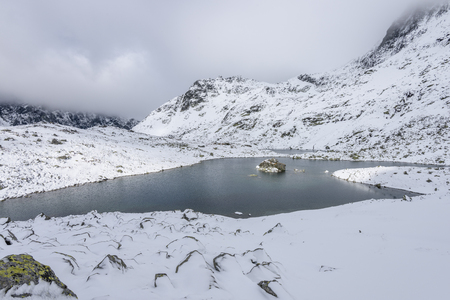 panoramic view of Tatra mountains in Slovakia covered with snow and hiding in mist. high altitudeの写真素材