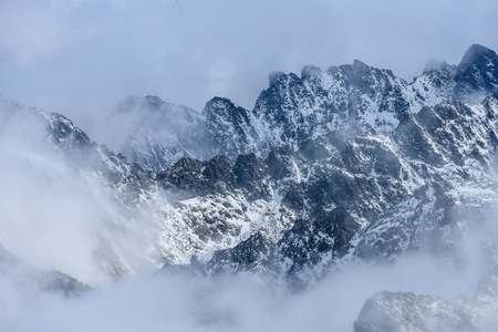 panoramic view of Tatra mountains in Slovakia covered with snow and hiding in mist. high altitudeの写真素材