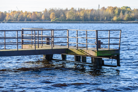 old bridge with rusty metal rails near sea portの写真素材