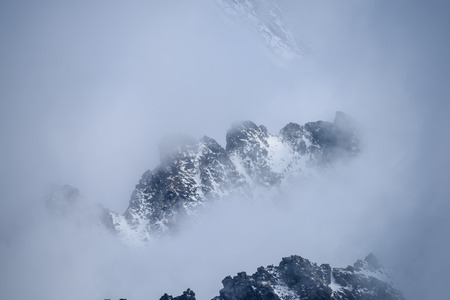mist covered mountains with blue sky and tourist trails in slovakia