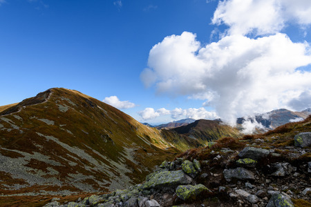 western carpathian mountain tops in  autumn covered in mist or clouds