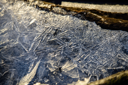 frozen ice crystals on river in winter lights