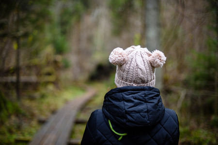 young woman with hat enjoying nature in autumn in forestの写真素材