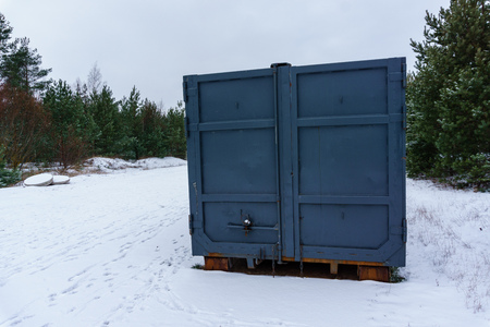 Trash bin at the side of street in winter with lip garbage container winter snowの写真素材