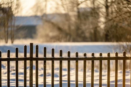 wooden plank fence details  in countryside in winter time, with lots of snow and frozen iceの写真素材