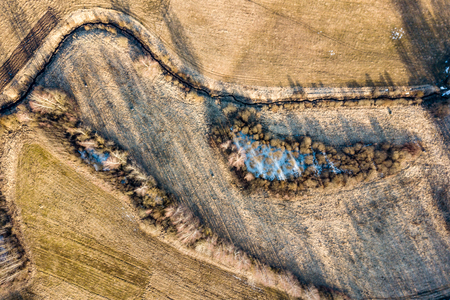 drone image. aerial view of rural area with houses and road network. populated area Dubulti near Jekabpils, Latvia. spring day, clear fieldsの写真素材