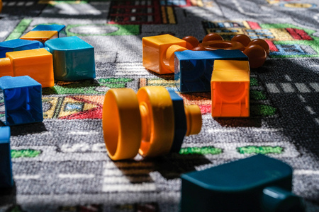 child toys left on the rug in living room. blocks and balls
