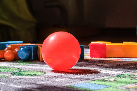 child toys left on the rug in living room. blocks and ballsの写真素材