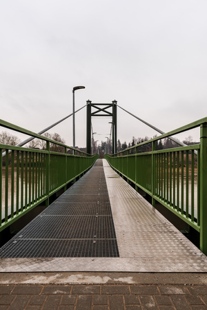 metal pedestrian bridge details in city of Bauska, Latvia. abstract texture and lines in cloudy spring dayの写真素材