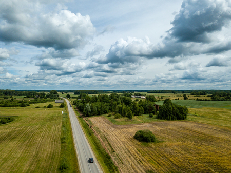 drone image. aerial view of rural area with fields and road network. latviaの写真素材