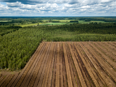 drone image. aerial view of rural area with fields of turf fuel cells development and storage in Latviaの写真素材