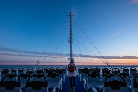 dramatic red sunrise over the baltic sea seen through ships ropes and metal railingsのeditorial素材