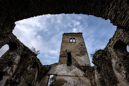 ruins of old abandoned church with red bricks and stone in early autumn in Slovakiaの写真素材