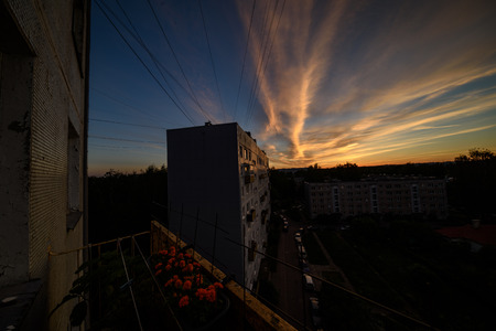 dramatic sunset over the city of Riga, Latvia, rooftops and dark red clouds on black skyの写真素材