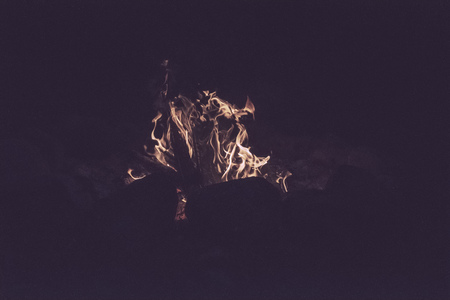 woods are burning in fireplace, warm, heat, fire in darkness. camping in nature in summer - vintage...